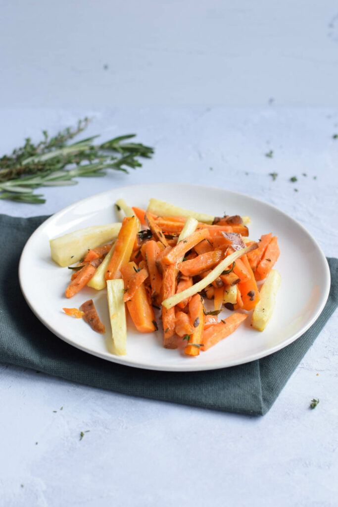 A plate with low FODMAP oven roasted carrot, parsnip and sweet potato