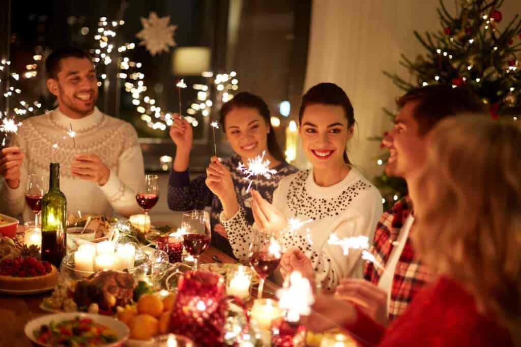 People at Christmas dinner with Christmas lights