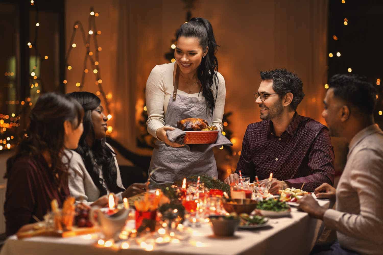 People sitting on the table having a turkey dinner