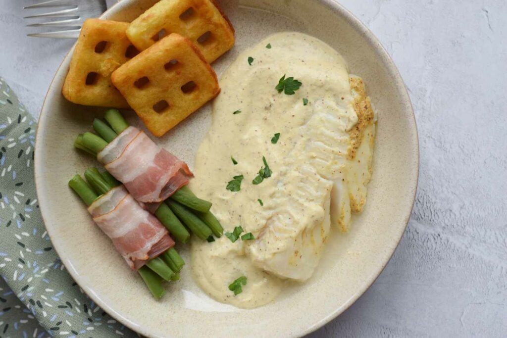 Low FODMAP codfish in mustard sauce photographed from above