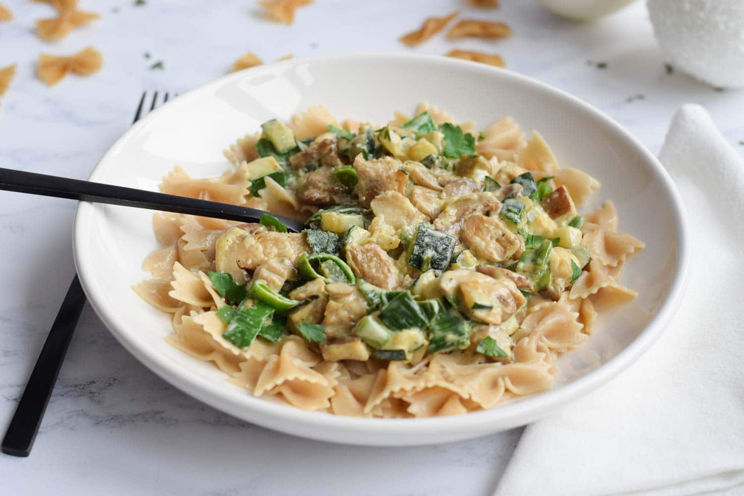 A plate of low FODMAP pasta with mushrooms in cream sauce