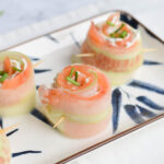 Low FODMAP salmon cucumber rolls with cream cheese on a plate