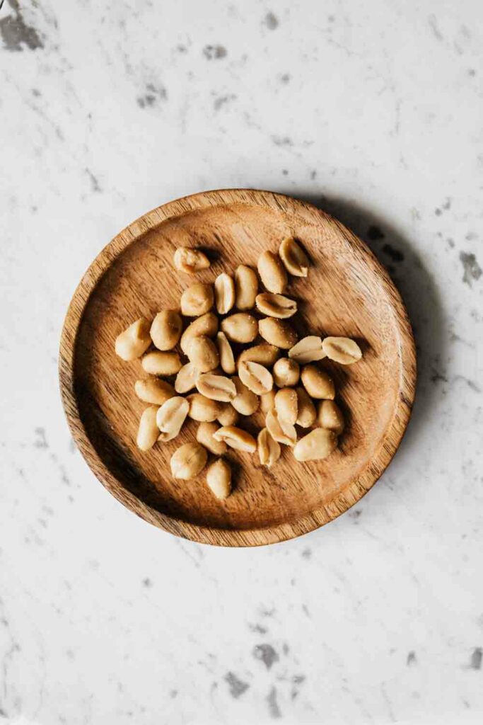 Peanuts on a wooden plate
