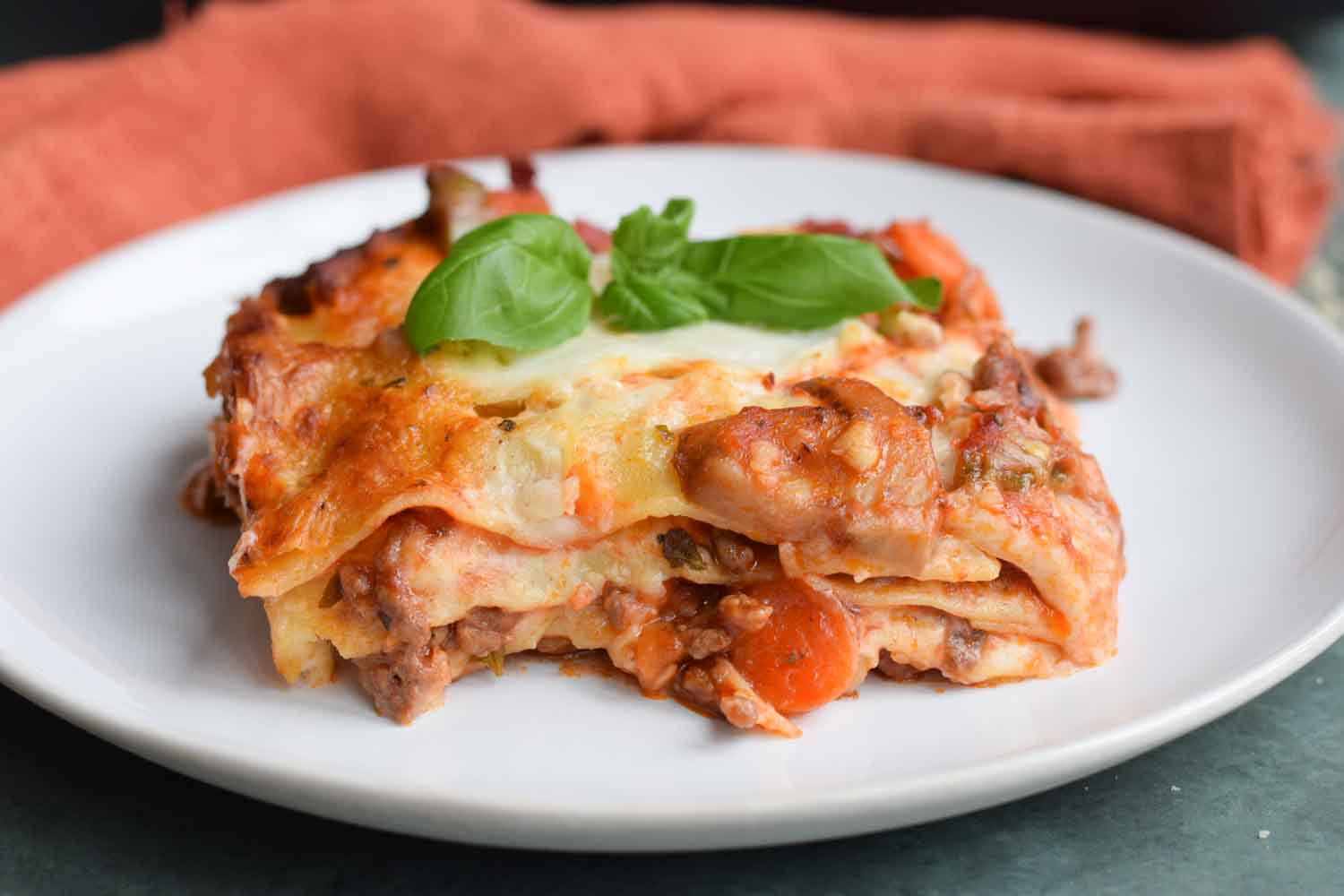 A piece of low FODMAP lasagna bolognese on a plate