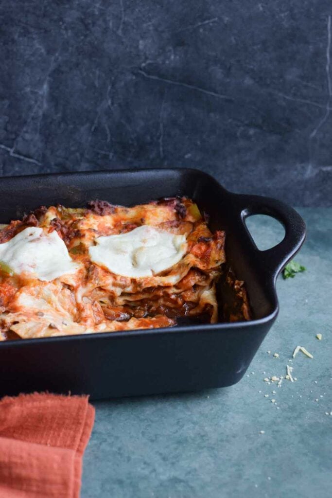 A dish of lasagna photographed from the side