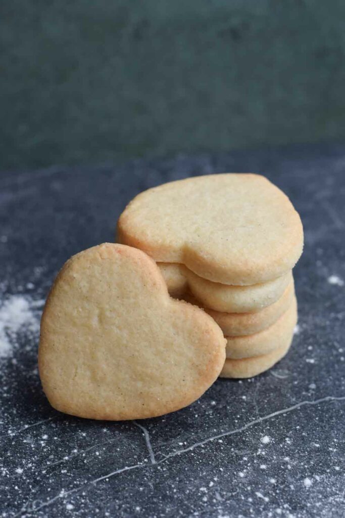 A stack of gluten-free sugar cookies in a heart shape