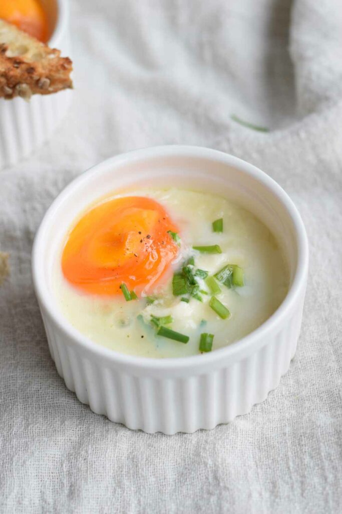 A bowl of low FODMAP baked eggs with salmon