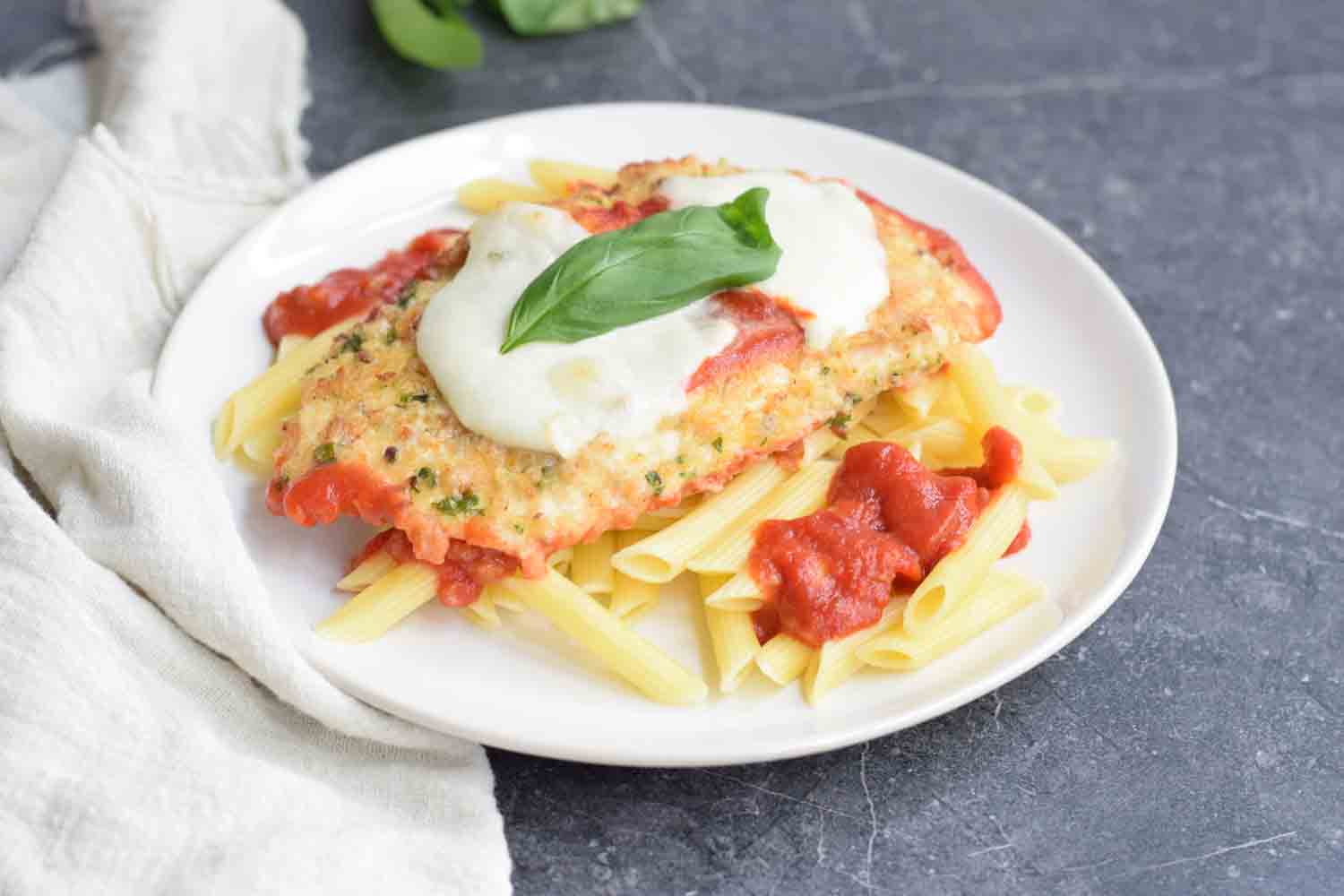 Low FODMAP chicken parmesan with pasta on a plate