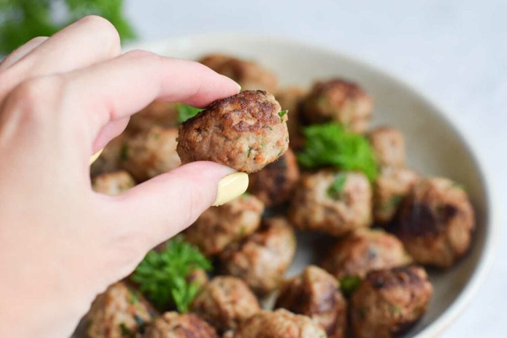 Somebody holding a low FODMAP meatball