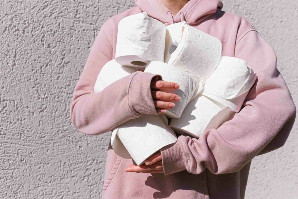 A person holding toilet paper