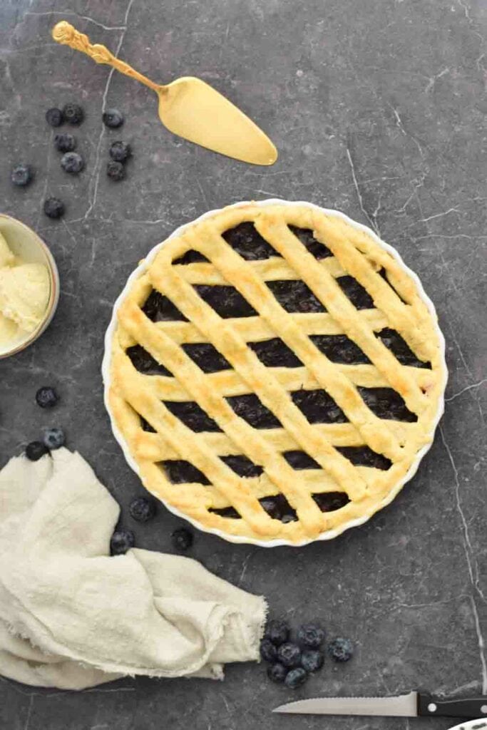 A low FODMAP blueberry pie on a black background