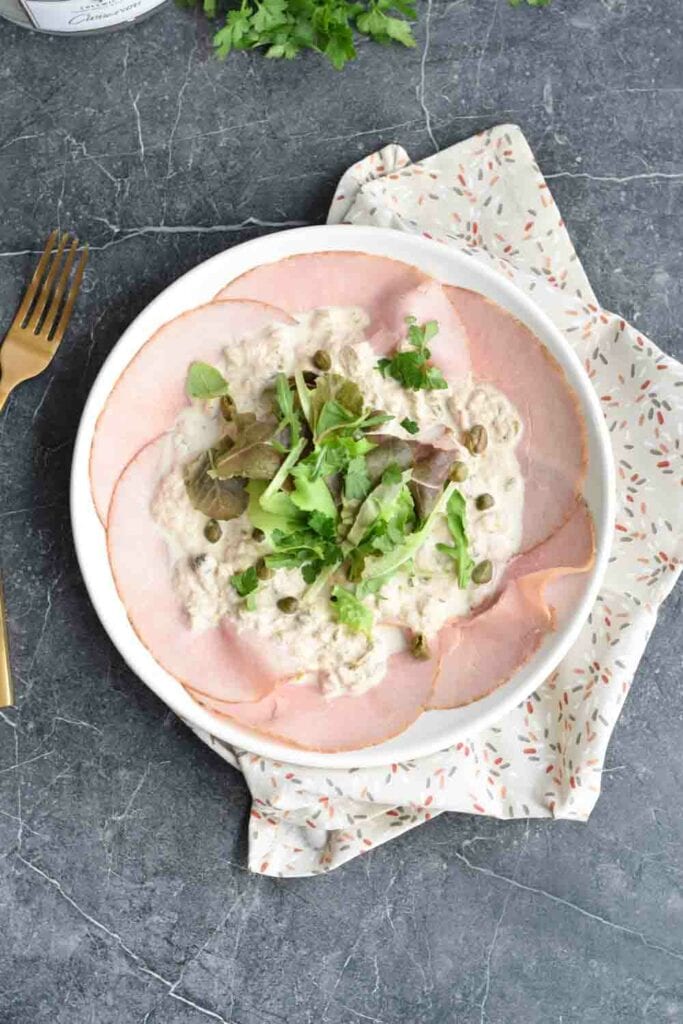 A plate of low FODMAP vitello tonnato photographed from above