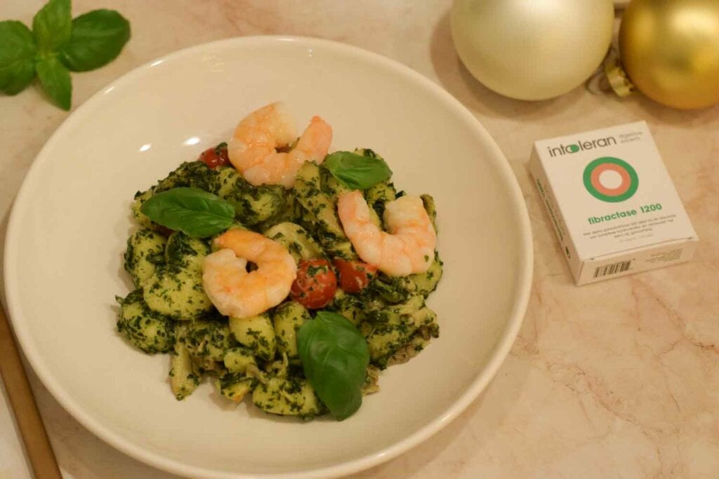 A plate of gnocchi with shrimps with a box of Fibractase next to it