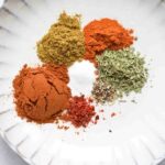 A plate with spices for low FODMAP taco seasoning