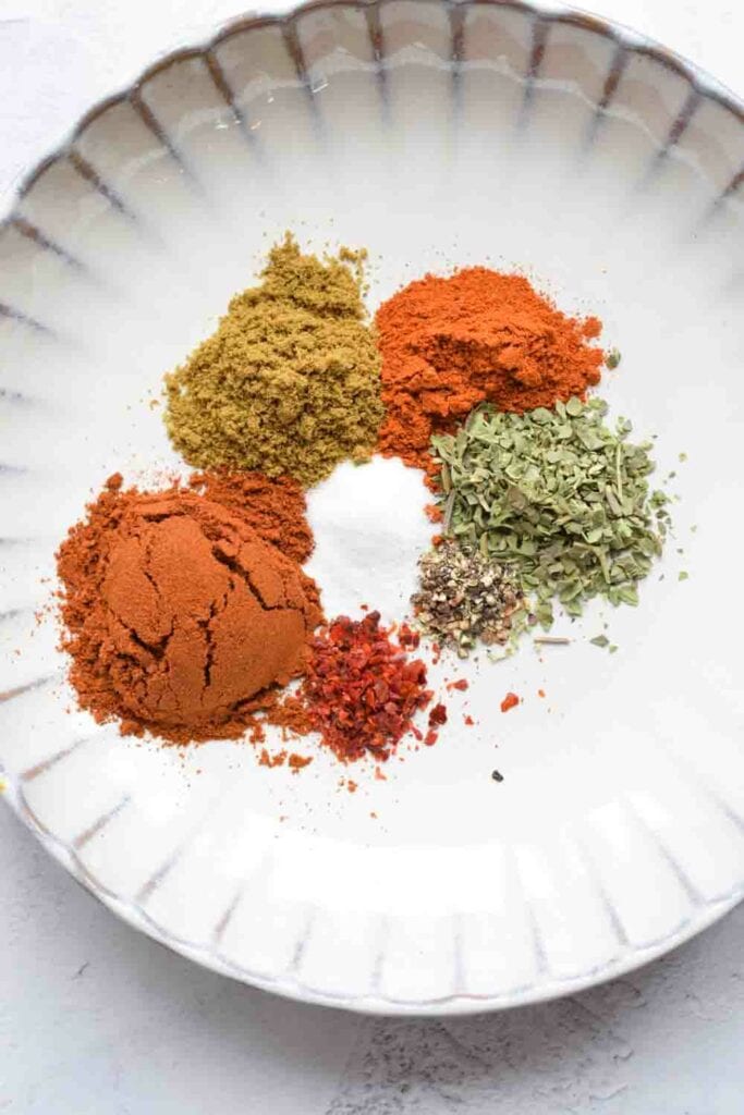 A plate with spices for low FODMAP taco seasoning