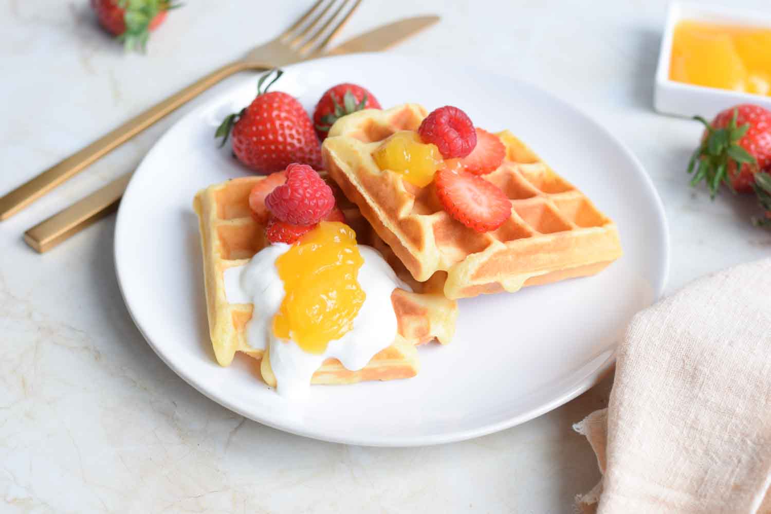 A plate with low FODMAP waffles and lemon curd